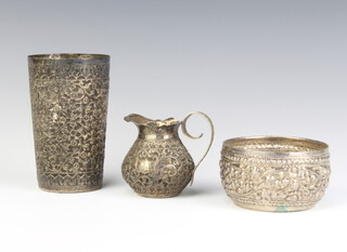 An Edwardian repousse silver beaker, jug and bowl, 281 grams 