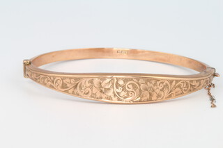 A 9ct rose gold hinged hollow bangle with engraved decoration 7.3 grams 