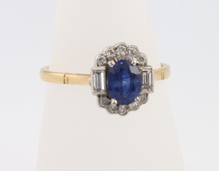 An 18ct yellow gold oval sapphire and diamond cluster ring size M 