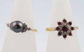 An 18ct yellow gold ruby and diamond cluster ring size I 1/2 and a 14ct yellow gold grey pearl diamond ring size I 