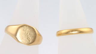 A 22ct yellow gold wedding band, size N 1/2, 3.5 grams and an 18ct yellow gold signet ring size R 5 grams (cut) 