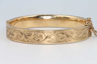 A 9ct yellow gold engraved bangle 15.4 grams