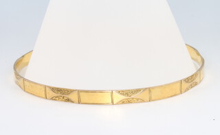 A 9ct yellow gold engraved arm bangle, 23.3 grams