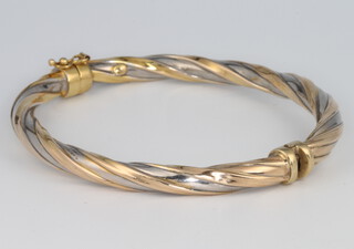 A 9ct two colour gold bangle, 9.3 grams