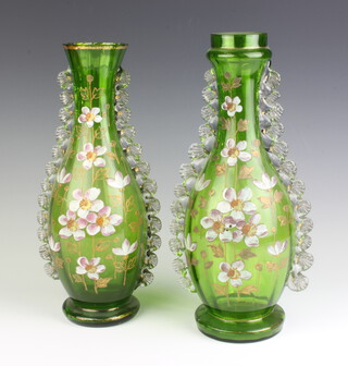 A near pair of Continental painted green glass baluster vases decorated with flowers 32cm 