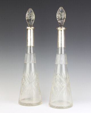 A pair of cut glass tapered decanters with 800 standard collars 43cm 