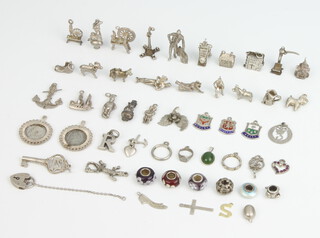 A quantity of silver charms 105 grams