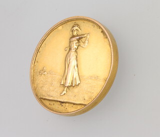 A 9ct yellow gold golf medallion depicting a lady golfer 8.7 grams