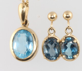 A 9ct yellow gold topaz pendant and earrings 