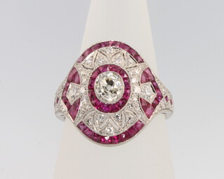 An Edwardian style diamond and ruby cluster ring the centre brilliant cut stone approx 0.6ct surrounded by brilliant cut diamonds approx. 0.3ct and rubies approx 1.3ct, size N 1/2