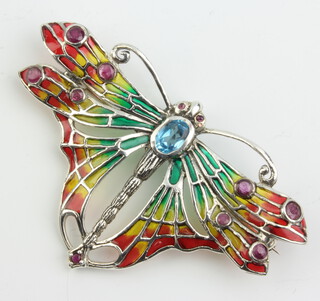 A silver butterfly brooch decorated with blue topaz, enamels and rubies 