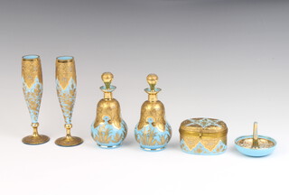 An Edwardian turquoise glass gilt decorated dressing table set comprising ring holder, oval trinket box, 2 scents and 2 vases 