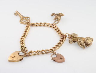 A 9ct yellow gold charm bracelet with 3 charms and 2 padlocks, 40 grams 