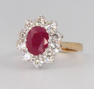 An 18ct yellow gold treated ruby and diamond cluster ring, the centre stone approx. 2.25ct, the diamonds 1.5ct, size M 1/2