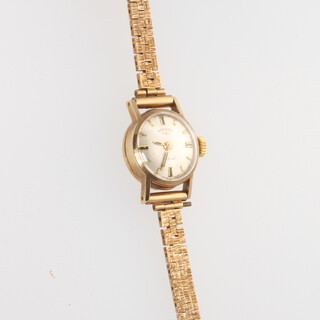 A lady's 9ct yellow gold Rotary wristwatch on a ditto bark finished bracelet 12 grams 