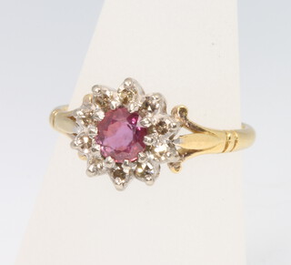 An 18ct yellow gold ruby and diamond cluster ring 4.2 grams, size N 1/2