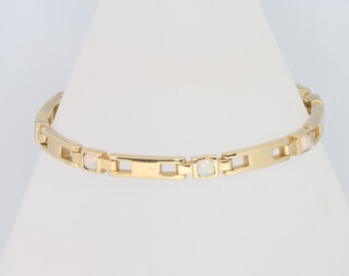 A 14ct yellow gold opal set diamond bracelet, 10.9 grams