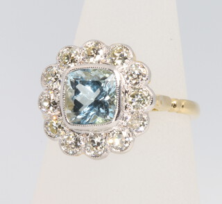 An 18ct yellow gold aquamarine and diamond cluster ring, the centre stone approx 1.5ct, surrounded by 12 brilliant cut diamonds approx. 1.2ct, size O 