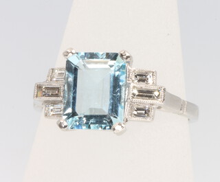 A platinum aquamarine and diamond ring, the centre stone approx. 2.5ct flanked by baguette cut diamonds approx. 0.3ct, size O