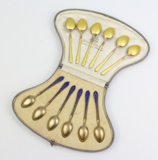 A set of 6 Norwegian silver and enamelled teaspoons in a fitted case together with a set of 6 silver and guilloche enamel ditto 