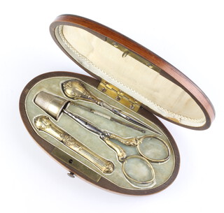 A 19th Century oval fruitwood etui fitted with 5 gilt accessories 