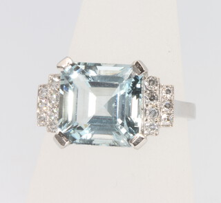 A platinum Art Deco style aquamarine and diamond ring, the centre stone approx. 4.5ct flanked by brilliant cut diamonds approx. 0.2ct, size N 