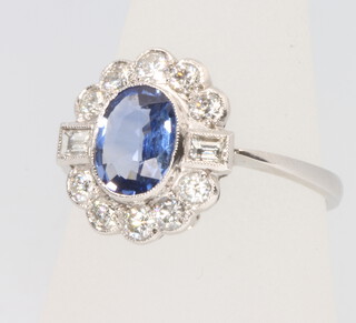 A platinum Edwardian style oval sapphire and diamond ring, the centre stone approx. 1.25ct surrounded by brilliant and baguette cut diamonds, size P 