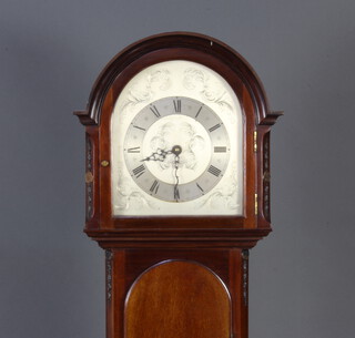 A 1920's longcase clock with 23.5cm arched silvered dial with Roman numerals, with quartz movement, contained in a mahogany case with sliding hood and long door, 170cm h 