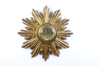 A 1930's timepiece with quartz movement with gilt dial, contained in a carved gilt wood sunburst case 54cm 