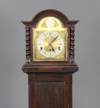 An 8 day striking longcase clock with 19cm arched gilt dial and silvered chapter ring, contained in an oak arch shaped case with spiral turned columns to the side 154cm h, the hood is fixed and access to the movement is gained from a door at the back  