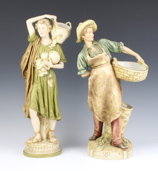 A Royal Dux figure of a young man carrying a basket 40cm, a ditto of a robed lady carrying a basket 43cm 