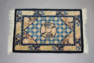 A blue and peach ground Chinese rug 95cm x 60cm 