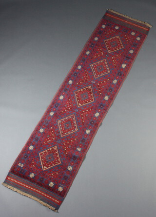 A red and blue ground Meshwani runner with 5 diamonds to the centre within a multi row border 248cm x 62cm