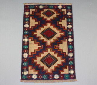 A tan, blue and brown ground belouche rug with 3 diamonds to the centre within a multi row border 133cm x 86cm