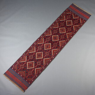 A red and blue ground Mashwani runner with 6 stylised octagons to the centre 240cm x 242cm x 59cm