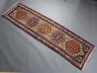 A white, blue and red ground Persian runner with 5 stylised diamonds to the centre within a multi row border 283cm x 80cm 