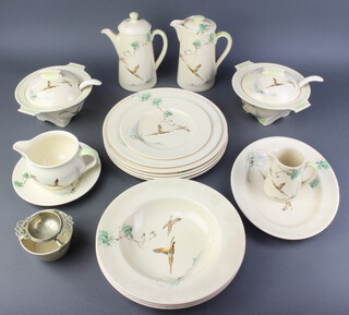 A Royal Doulton coffee and dinner service, decorated with pheasants, design B5803 comprising coffee pot, hot water pot, 1 small plate, 1 medium plate, 4 large plates, 2 tureens, covers and ladles, a jug, sauce boat and stand, oval plate, 3 bowls and a tea strainer stand