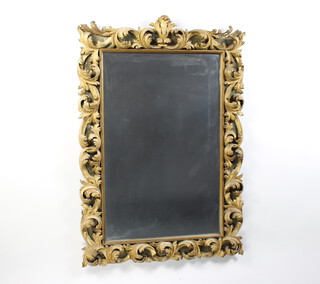 A rectangular plate wall mirror contained in an Italianate style decorative gilt wood and plaster frame 113cm h x 79cm 