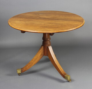 A Regency style circular light oak breakfast table raised on a turned column and tripod base with brass caps and casters 74cm h x 95cm diam. 