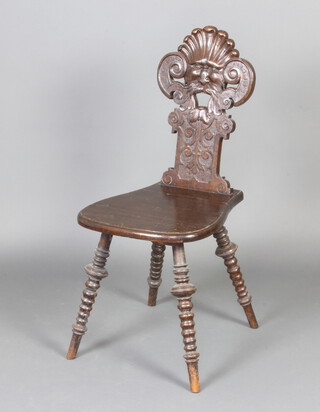 A Victorian Continental carved oak hall chair decorated The Green Man, raised on turned supports 