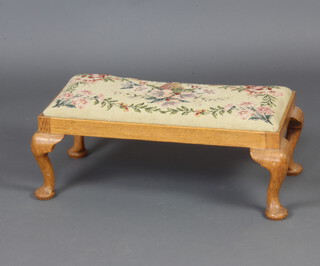 A rectangular light oak footstool with Berlin woolwork seat raised on cabriole supports 28cm h x 69cm w x 31cm d 