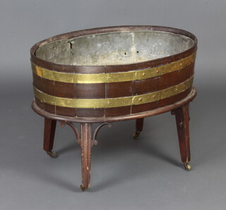 A 19th Century oval coopered mahogany wine cooler raised on associated stand 54cm h x 73cm w x 49cm d, complete with zinc liner 