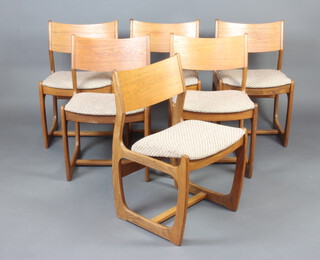 A set of mid 20th Century teak Astro style bar back dining chairs with upholstered drop in seats, raised on shaped supports with undertier 
