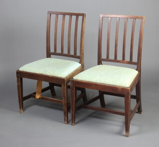 Gillows of Lancaster, a pair of 19th Century mahogany stick and rail back dining chairs with upholstered drop in seats the back marked Gillows Lancaster