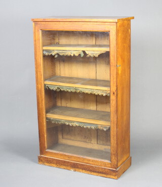 A Victorian oak bookcase fitted adjustable shelves enclosed by a glazed panelled door, raised on a platform base 130cm h x 78cm w x 36cm d 