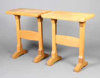 A pair of rectangular Arts and Crafts style light oak occasional tables with H framed stretcher, raised on stepped supports 74cm h x 62cm w x 36cm d 