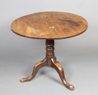 A 19th circular mahogany snap top tea table raised on a turned pillar and tripod base 64cm h x 78cm diam. 
