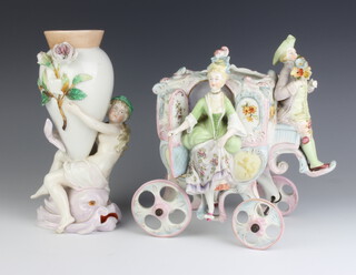 A 19th Century German porcelain centrepiece in the form of a coach with a driver and lady 21cm together with a ditto vase supported by a semi-clad lady 24cm 