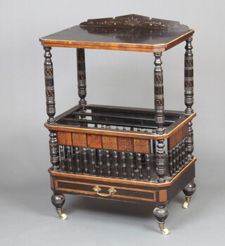 A Victorian aesthetic movement ebonised and walnut Canterbury with raised back, having bobbin turned decoration and drawer to the base 91cm h x 61cm w x 40cm d 