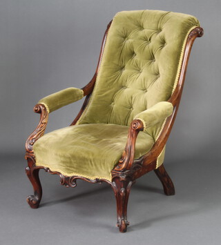 A William IV mahogany show frame armchair upholstered in green buttoned dralon, raised on cabriole supports 